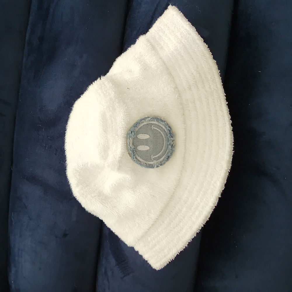 Boys white terrycloth bucket hat with smiley face.
